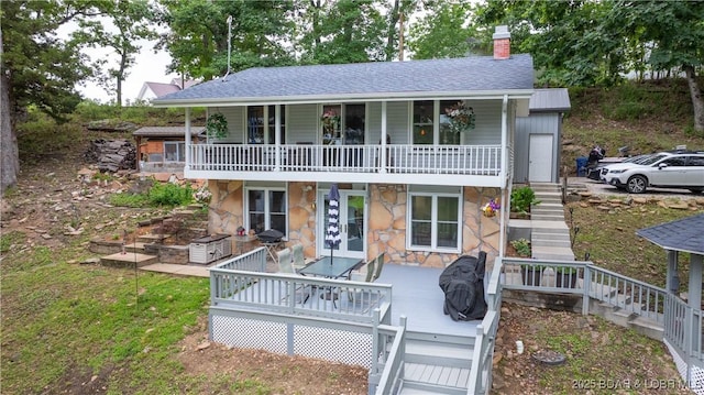 168 Moeller Way, Camdenton, MO 65020 - view of front of house featuring stairs, stone siding, a chimney, a deck, and roof with shingles