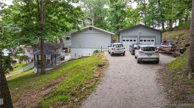 168 Moeller Way, Camdenton, MO 65020 - view of side of home with a garage, a chimney, and an outbuilding