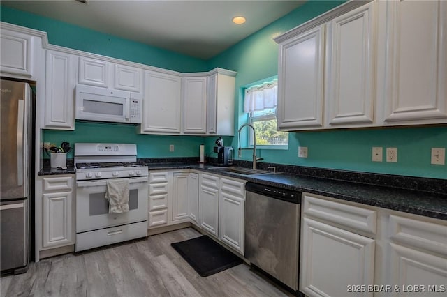 9 Hidden Creek Ct, Camdenton, MO 65020 - kitchen featuring appliances with stainless steel finishes, white cabinets, light wood-type flooring, and recessed lighting