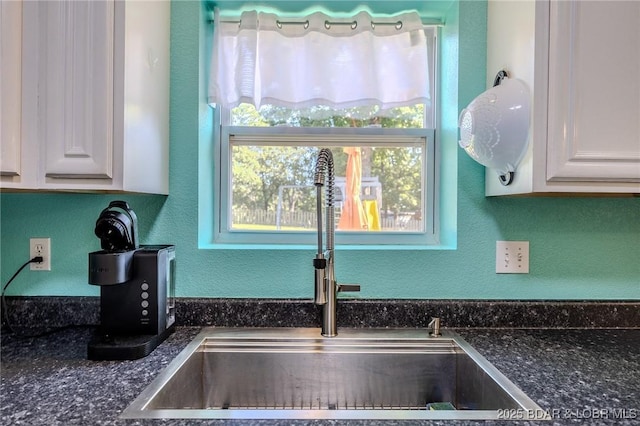 9 Hidden Creek Ct, Camdenton, MO 65020 - kitchen view of dark countertops, white cabinetry, and a textured wall
