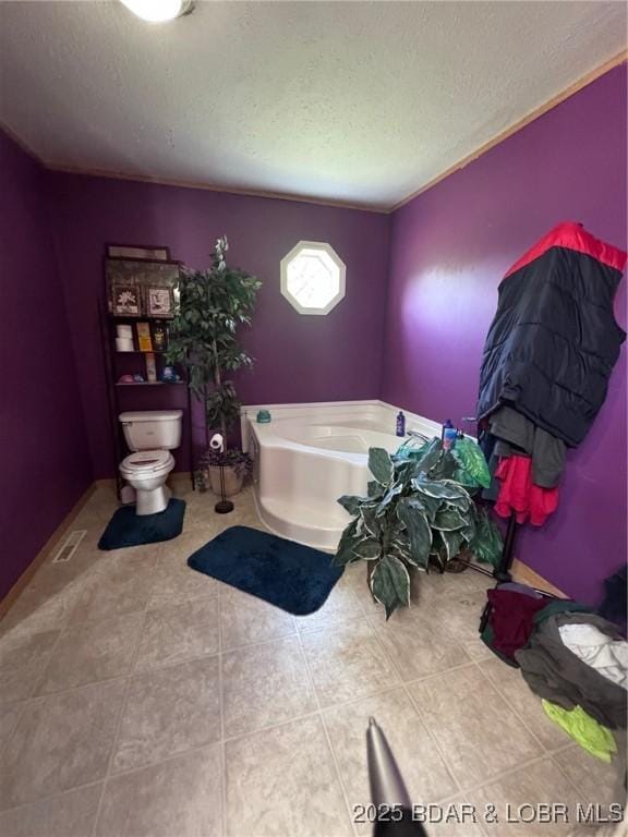 974 State Rte E, Montreal, MO 65591 - bathroom with a textured ceiling, a bath, and tile patterned flooring