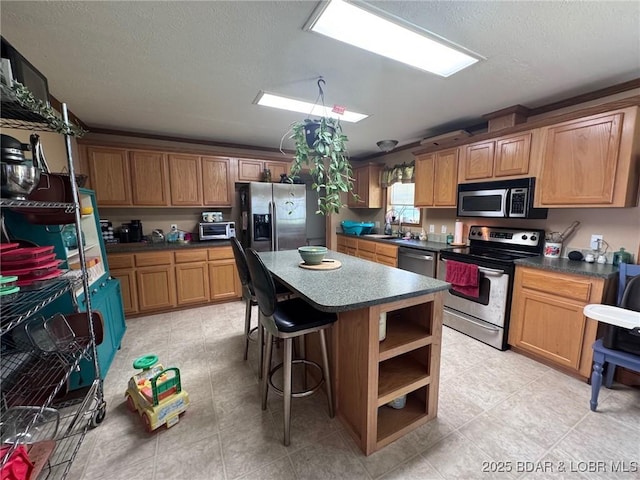 974 State Rte E, Montreal, MO 65591 - kitchen with stainless steel appliances, a kitchen island, open shelves, a textured ceiling, and dark countertops