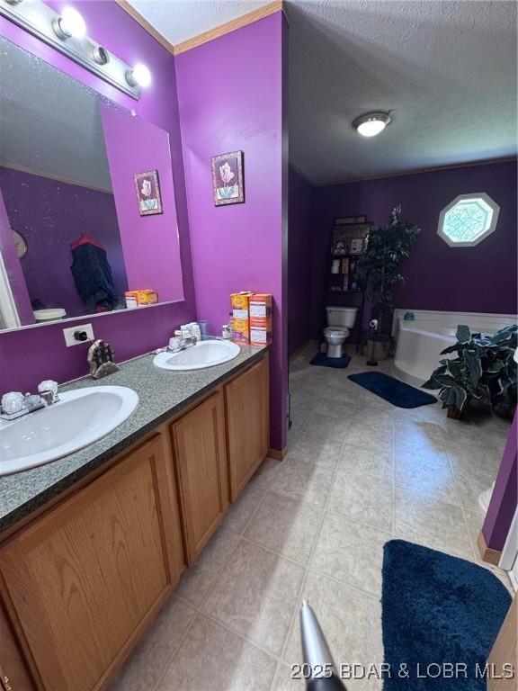 974 State Rte E, Montreal, MO 65591 - full bathroom featuring a textured ceiling, double vanity, tile patterned flooring, and a tub to relax in