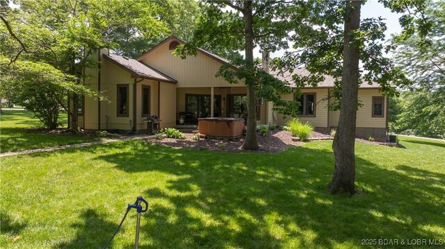 146 Palmer Dr, Lake Ozark, MO 65049 - back of property featuring a hot tub and a yard