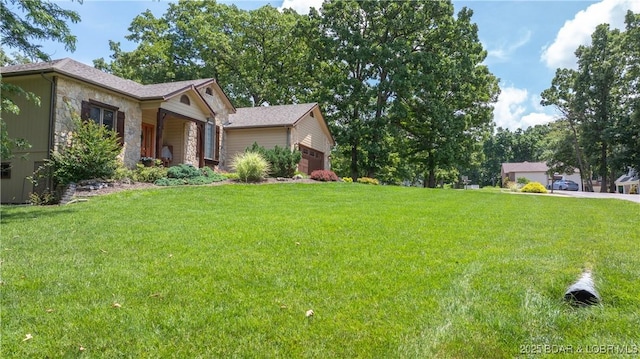 146 Palmer Dr, Lake Ozark, MO 65049 - view of green lawn featuring an attached garage