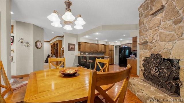 146 Palmer Dr, Lake Ozark, MO 65049 - dining space featuring a chandelier, light wood finished floors, recessed lighting, and a fireplace