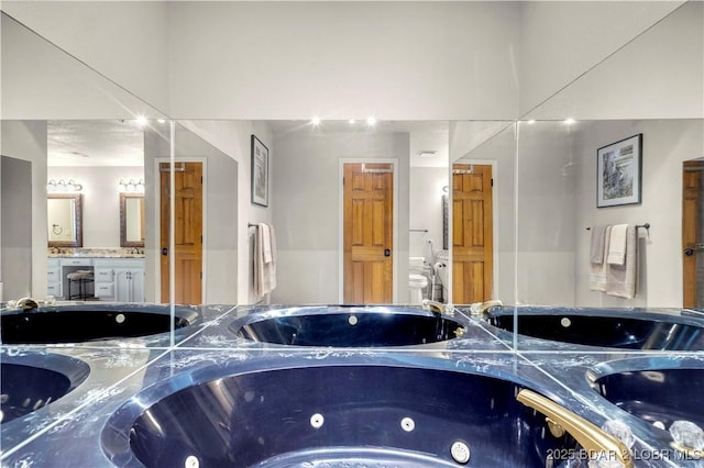 1759 Chimney Pt, Sunrise Beach, MO 65079 - bathroom with vanity and a whirlpool tub