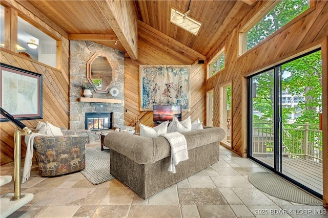 1759 Chimney Pt, Sunrise Beach, MO 65079 - living room featuring stone tile floors, a wooden ceiling with exposed beams, wood walls, a stone fireplace, and high vaulted ceiling