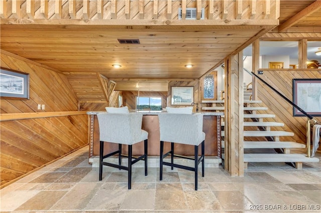 1759 Chimney Pt, Sunrise Beach, MO 65079 - kitchen with stone tile floors, wooden walls, and wooden ceiling