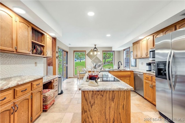 1759 Chimney Pt, Sunrise Beach, MO 65079 - kitchen featuring stainless steel appliances, tasteful backsplash, recessed lighting, a center island, and light stone countertops