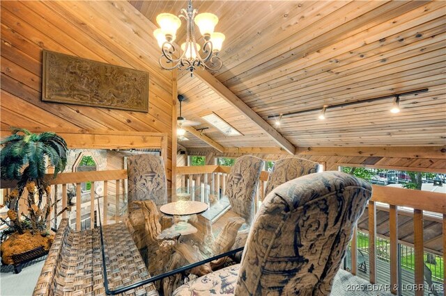 1759 Chimney Pt, Sunrise Beach, MO 65079 - dining room featuring track lighting, wood walls, wooden ceiling, a chandelier, and a skylight