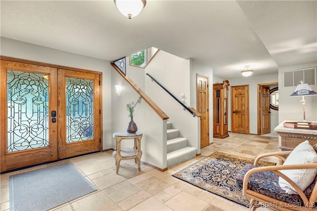 1759 Chimney Pt, Sunrise Beach, MO 65079 - entryway featuring french doors, stairway, and stone tile floors