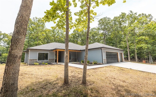 370 Via Appia Dr, Sunrise Beach, MO 65079 - prairie-style house with a garage, concrete driveway, stone siding, and a front yard