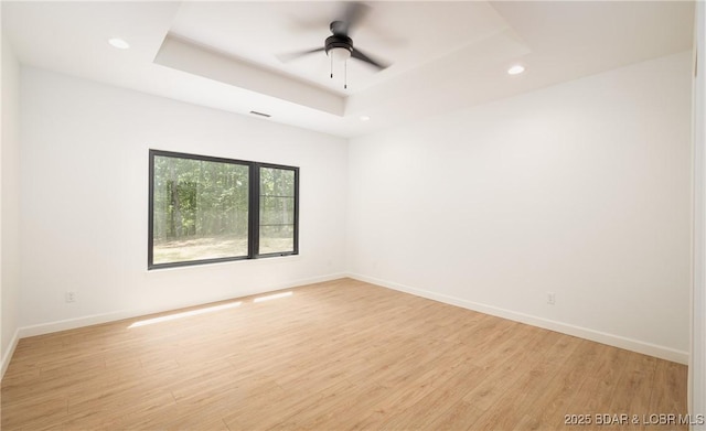 370 Via Appia Dr, Sunrise Beach, MO 65079 - unfurnished room featuring recessed lighting, light wood-style floors, a tray ceiling, and a ceiling fan