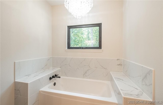 370 Via Appia Dr, Sunrise Beach, MO 65079 - bathroom featuring a bath and a chandelier