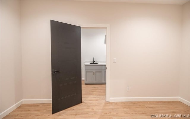 370 Via Appia Dr, Sunrise Beach, MO 65079 - empty room featuring a sink and light wood finished floors