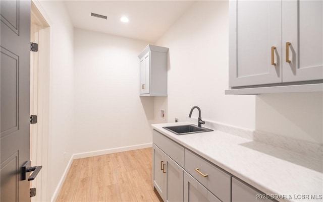 370 Via Appia Dr, Sunrise Beach, MO 65079 - laundry room featuring hookup for a washing machine, light wood-style floors, cabinet space, and recessed lighting