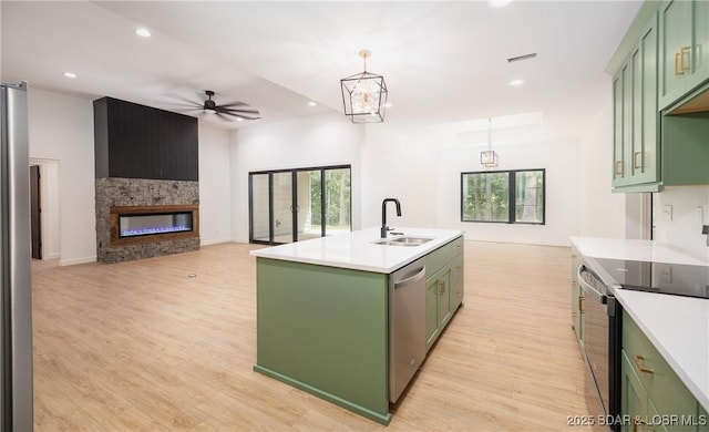 370 Via Appia Dr, Sunrise Beach, MO 65079 - kitchen with green cabinets, stainless steel appliances, healthy amount of natural light, ceiling fan, and recessed lighting