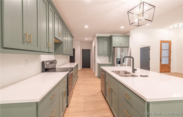 370 Via Appia Dr, Sunrise Beach, MO 65079 - kitchen featuring appliances with stainless steel finishes, light wood-style flooring, recessed lighting, light countertops, and a center island with sink