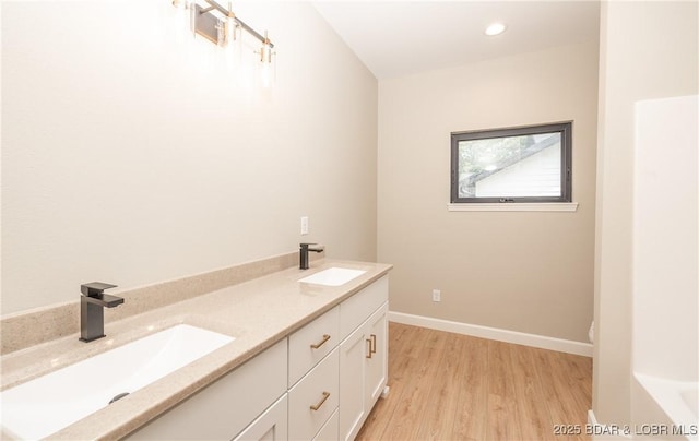 370 Via Appia Dr, Sunrise Beach, MO 65079 - full bath featuring wood finished floors, double vanity, a tub, and recessed lighting