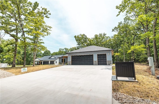 370 Via Appia Dr, Sunrise Beach, MO 65079 - view of front facade with stone siding and a detached garage