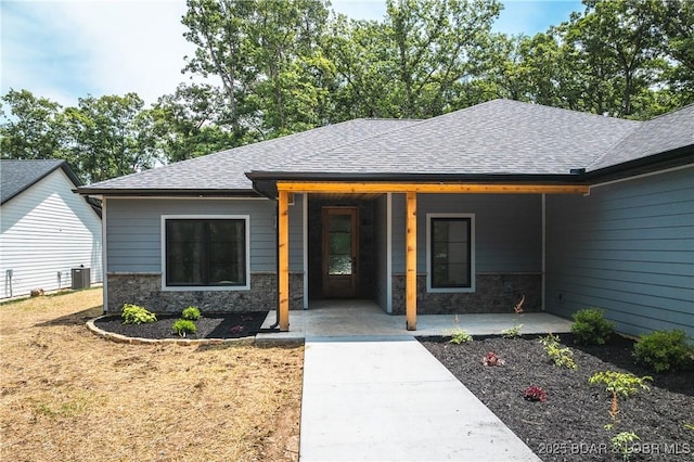 370 Via Appia Dr, Sunrise Beach, MO 65079 - property entrance featuring stone siding and a shingled roof