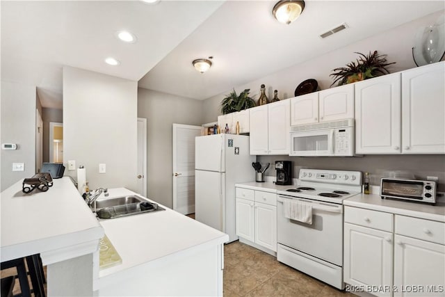 72 Palisades Lake View Dr Unit 2B, Lake Ozark, MO 65049 - kitchen featuring white appliances, a peninsula, white cabinets, a breakfast bar, and light countertops