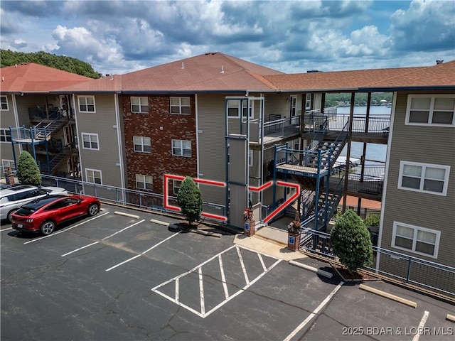 72 Palisades Lake View Dr Unit 2B, Lake Ozark, MO 65049 - view of apartment building / complex with uncovered parking and stairway