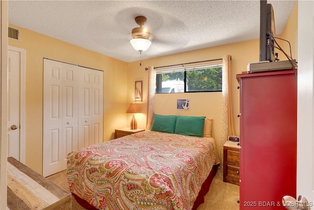 6620 Weston Point Dr Unit F4, Osage Beach, MO 65065 - carpeted bedroom with a closet, a textured ceiling, and a ceiling fan