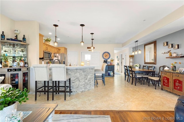 18132 Millstone Cove Rd Unit 334, Gravois Mills, MO 65037 - kitchen featuring stainless steel appliances, a breakfast bar, and pendant lighting