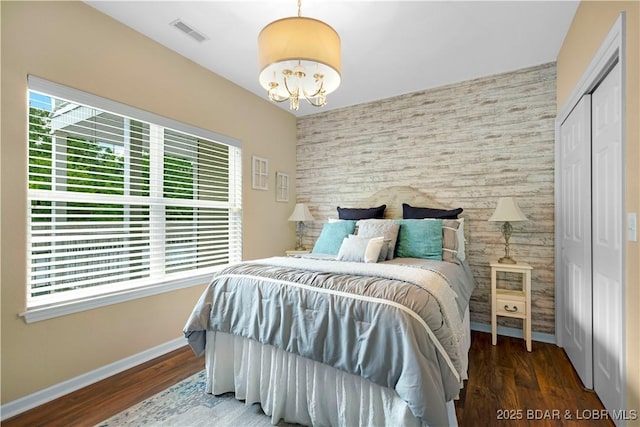 18132 Millstone Cove Rd Unit 334, Gravois Mills, MO 65037 - bedroom with an accent wall, a chandelier, wood finished floors, and a closet