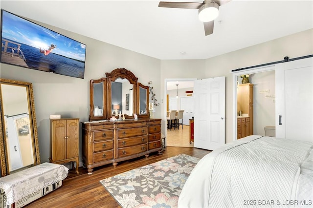 18132 Millstone Cove Rd Unit 334, Gravois Mills, MO 65037 - bedroom with wood finished floors, a barn door, ceiling fan, and connected bathroom