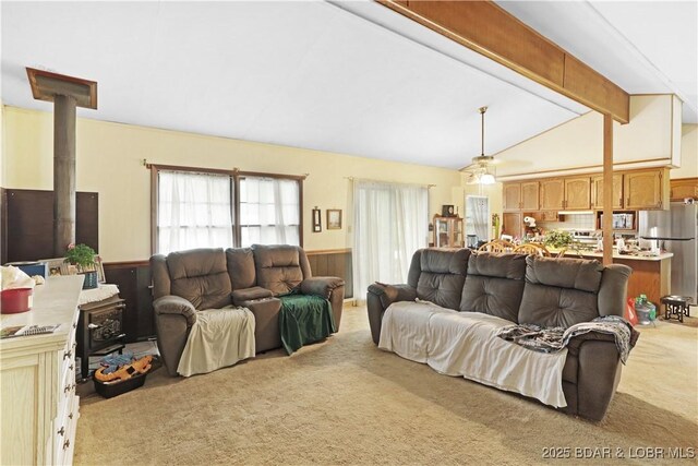 333 Crane Cove Rd, Sunrise Beach, MO 65079 - living room featuring light carpet, a wainscoted wall, a wood stove, and wood walls