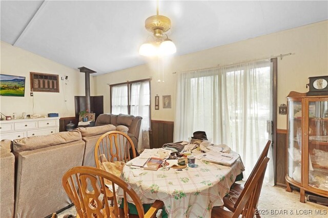 333 Crane Cove Rd, Sunrise Beach, MO 65079 - dining area with wainscoting, a wood stove, and carpet flooring