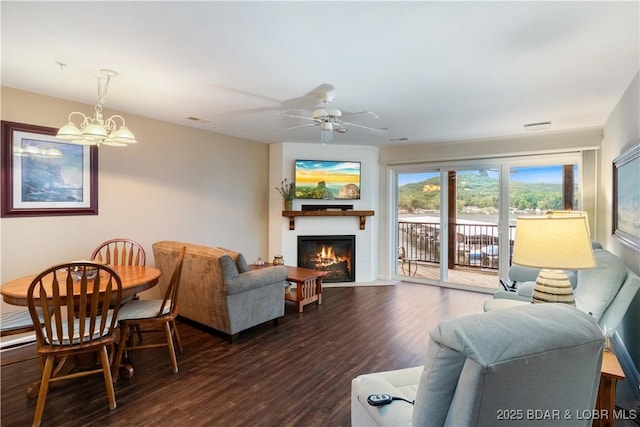686 Clearwater Dr Unit 2C, Camdenton, MO 65020 - living area with dark wood-style flooring, a fireplace, a chandelier, and a ceiling fan