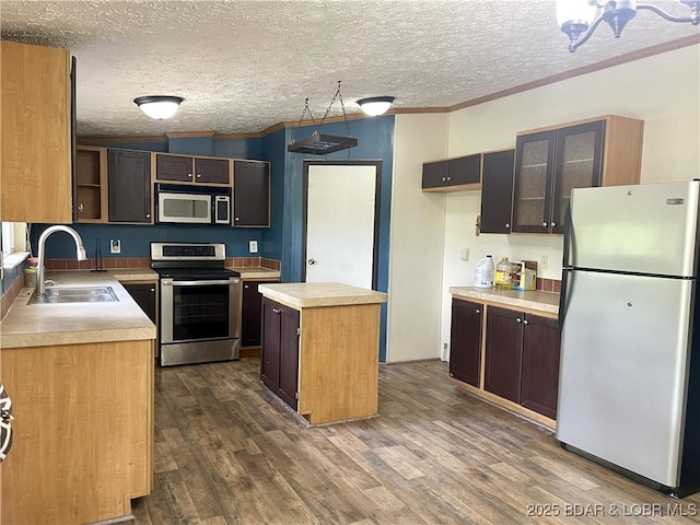 4712 Camden Line Rd, Lebanon, MO 65536 - kitchen with freestanding refrigerator, stainless steel electric range oven, a kitchen island, crown molding, and dark wood finished floors