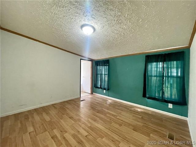 4712 Camden Line Rd, Lebanon, MO 65536 - spare room with a textured ceiling, wood finished floors, and ornamental molding