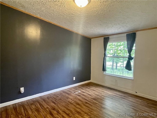 4712 Camden Line Rd, Lebanon, MO 65536 - spare room featuring wood finished floors, a textured ceiling, and ornamental molding