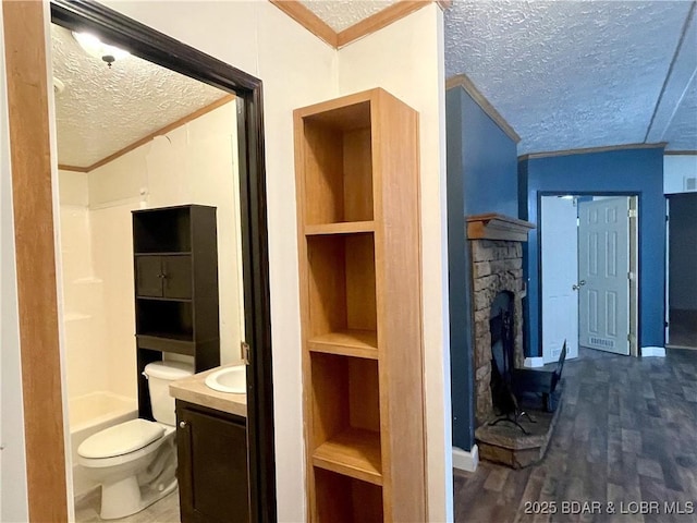 4712 Camden Line Rd, Lebanon, MO 65536 - bathroom with a textured ceiling, ornamental molding, vanity, built in features, and a fireplace