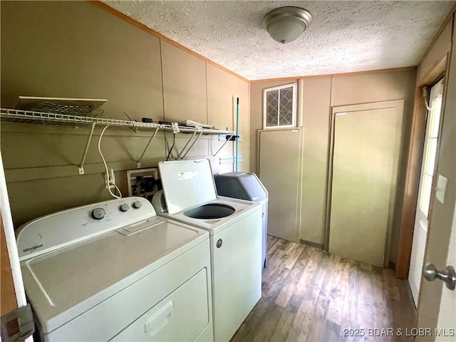 4712 Camden Line Rd, Lebanon, MO 65536 - laundry room with separate washer and dryer, light wood-type flooring, and a textured ceiling