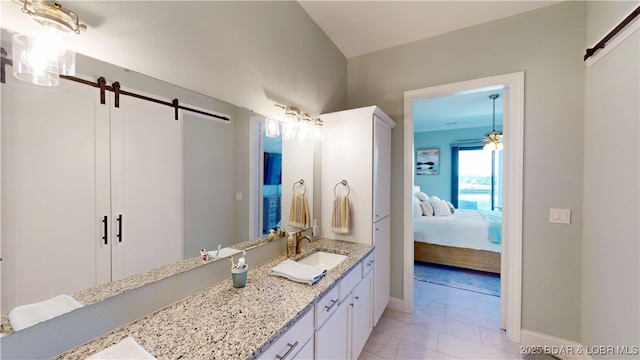 1065 Topsider Ln Unit 505, Osage Beach, MO 65065 - ensuite bathroom featuring marble look tiles, vanity, and a ceiling fan