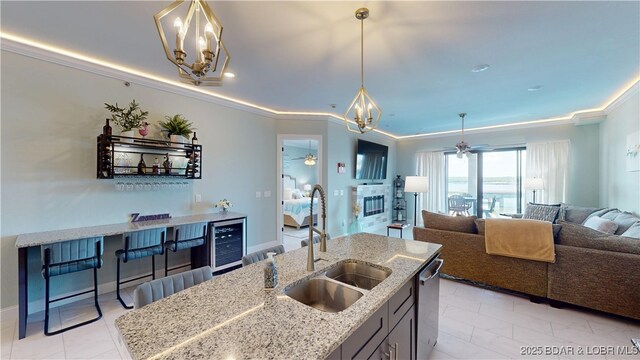 1065 Topsider Ln Unit 505, Osage Beach, MO 65065 - kitchen with a chandelier, open floor plan, wine cooler, ceiling fan, and ornamental molding