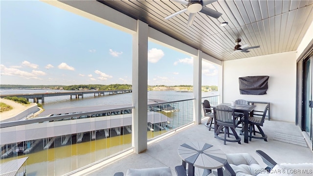 1065 Topsider Ln Unit 505, Osage Beach, MO 65065 - sunroom featuring a ceiling fan, a water view, and healthy amount of natural light