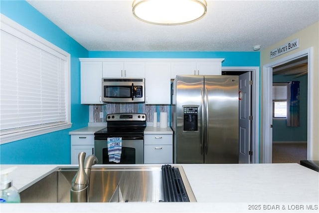 23 Willow Ridge Pt Unit 2B, Lake Ozark, MO 65049 - kitchen with stainless steel appliances, light countertops, and white cabinetry