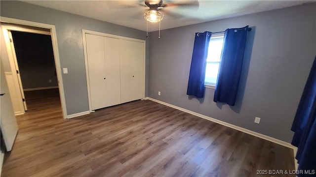 508 Hunter St N, Versailles, MO 65084 - unfurnished bedroom with wood finished floors, a closet, and a ceiling fan