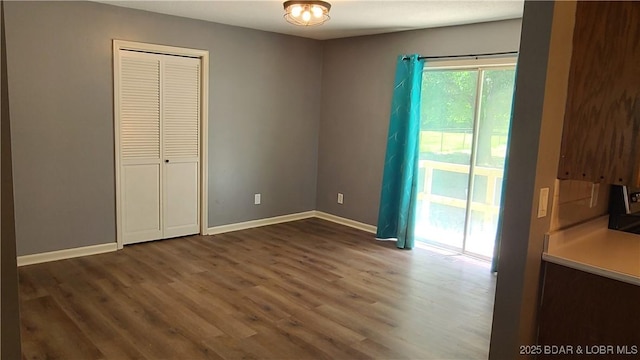 508 Hunter St N, Versailles, MO 65084 - unfurnished bedroom featuring wood finished floors and access to outside
