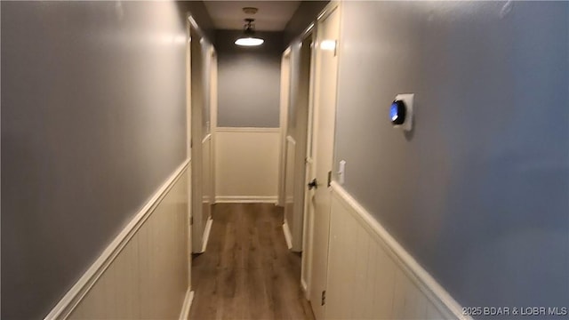 508 Hunter St N, Versailles, MO 65084 - hallway featuring a decorative wall, wood finished floors, and a wainscoted wall