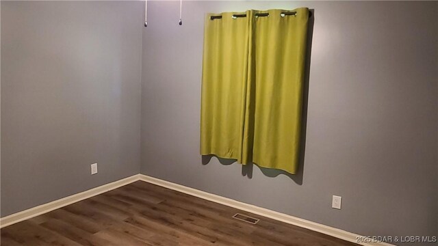 508 Hunter St N, Versailles, MO 65084 - empty room with dark wood-style floors and baseboards
