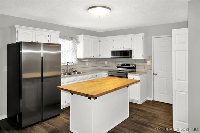 712 Passover Rd, Osage Beach, MO 65065 - kitchen featuring stainless steel appliances, butcher block countertops, white cabinetry, tasteful backsplash, and dark wood-style floors