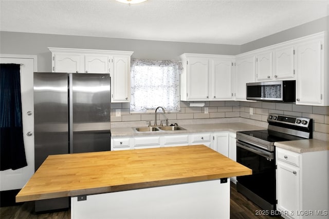712 Passover Rd, Osage Beach, MO 65065 - kitchen with stainless steel appliances, butcher block counters, white cabinetry, and dark wood-style floors